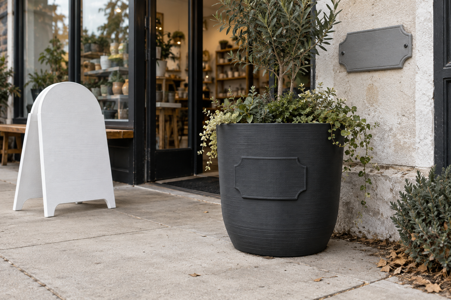 3D printed storefront planter, counter sign, and exterior plaque outside an independent shop